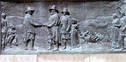 A bronze relief of first Puritans and founders of Massachusetts meeting with 