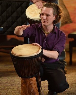 Young man playing the drum