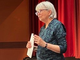 Woman speaking holding papers
