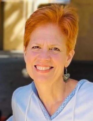 Head shot of a woman with red hair smiling